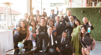 wedding guests smiling and waving on the sofia banquet hall balcony at noor los angeles
