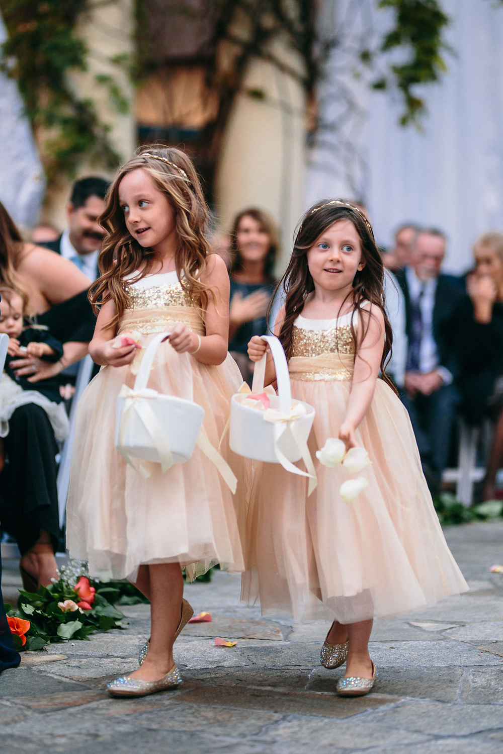 two flower girls in blush dresses at a wedding ceremony on the terrace at noor los angeles