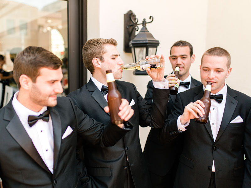 groom with groomsmen enjoying a beer
