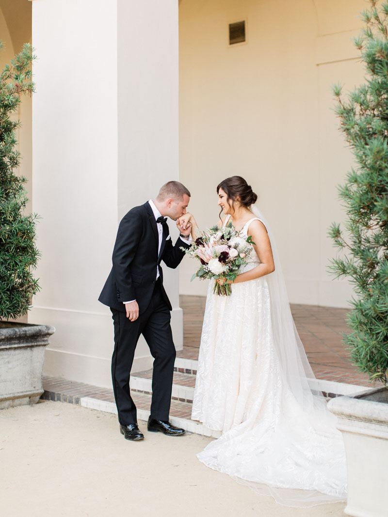 los angeles wedding groom kisses the brides hand in a beautiful first look moment