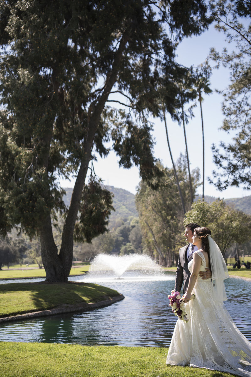 bride and groom walking by a fountain los angeles wedding