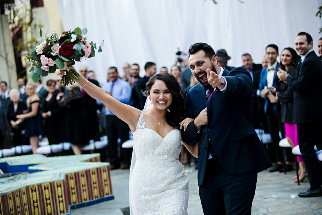 bride and groom celebrating just after exchanging vows on the terrace garden courtyard at NOOR banquet halls in pasadena