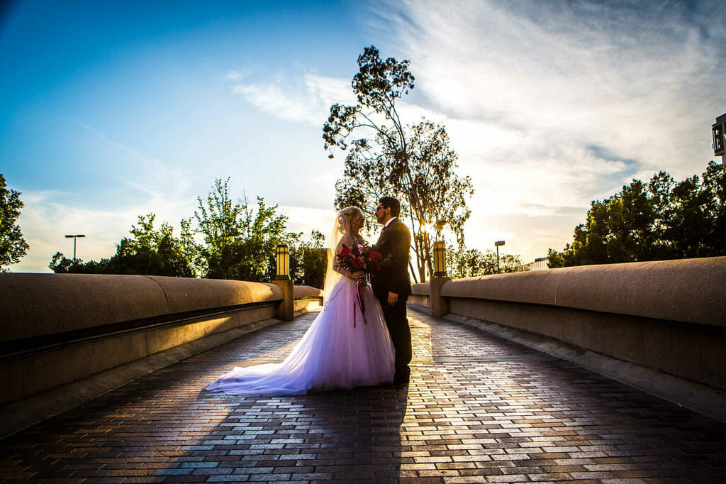 wedding couple embracing on noor's bridge to love with a blue sky and golden hour lighting