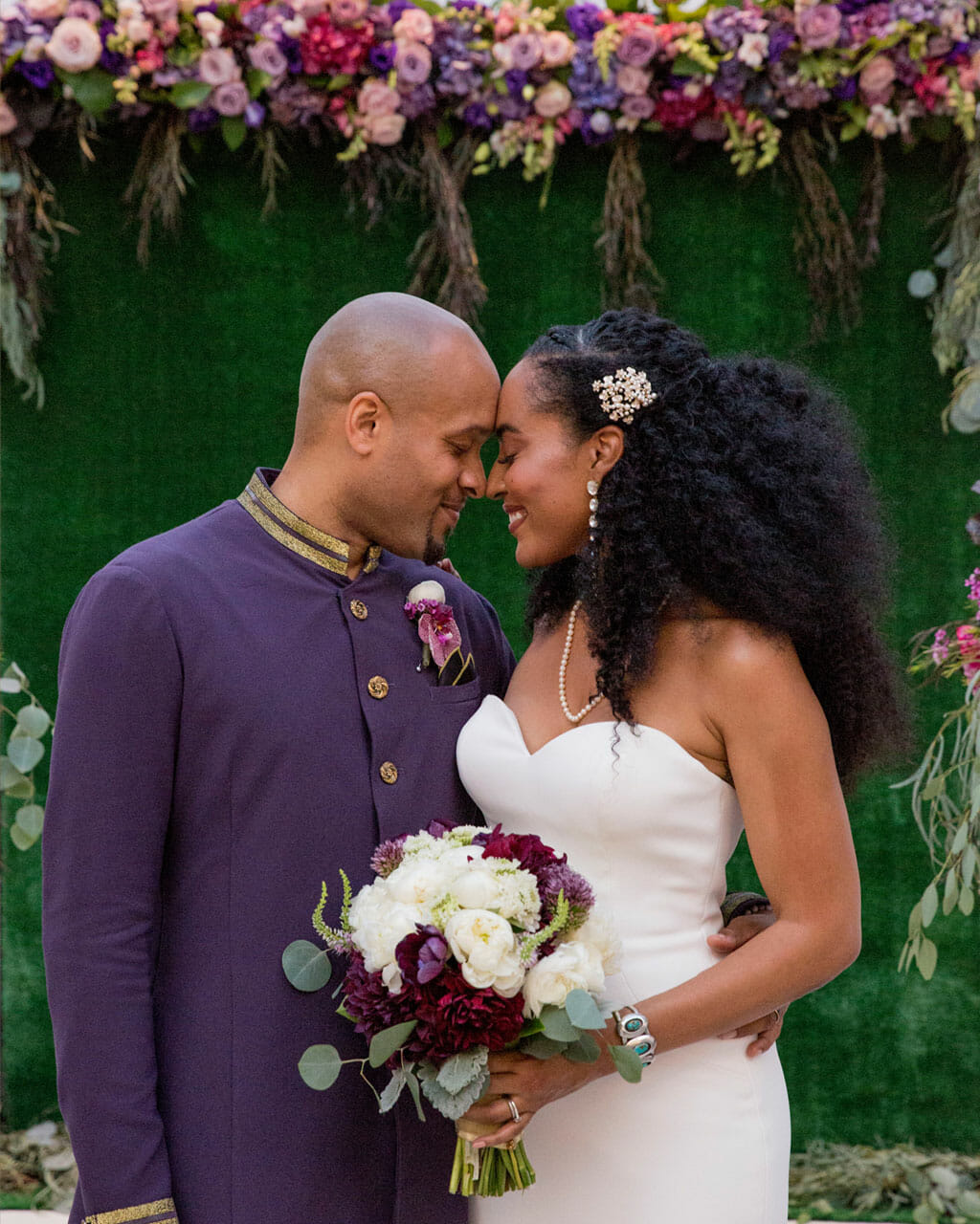wedding couple smiling in front of ceremony flowers on the noor terrace los angeles