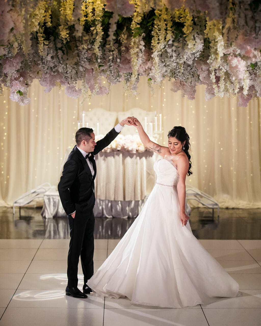 first dance under a canopy of flowers from a wedding at noor banquet hall in los angeles