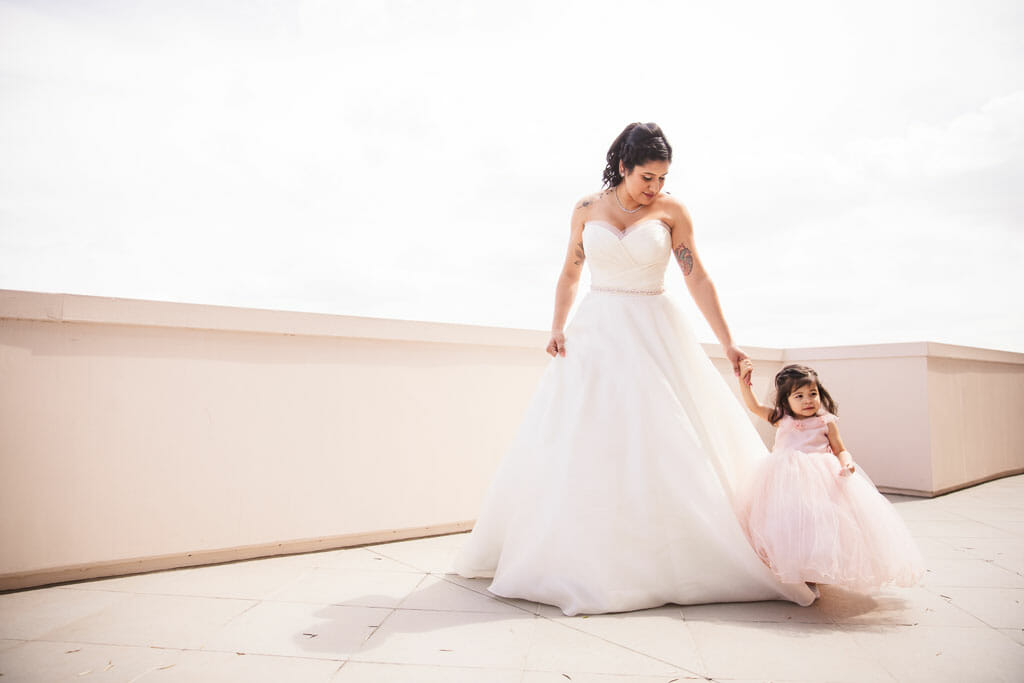 Bride with her little girl taking a walk in Pasadena before wedding ceremony