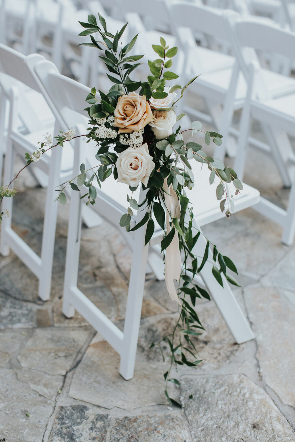 roses and greenery floral details at outdoor wedding ceremony