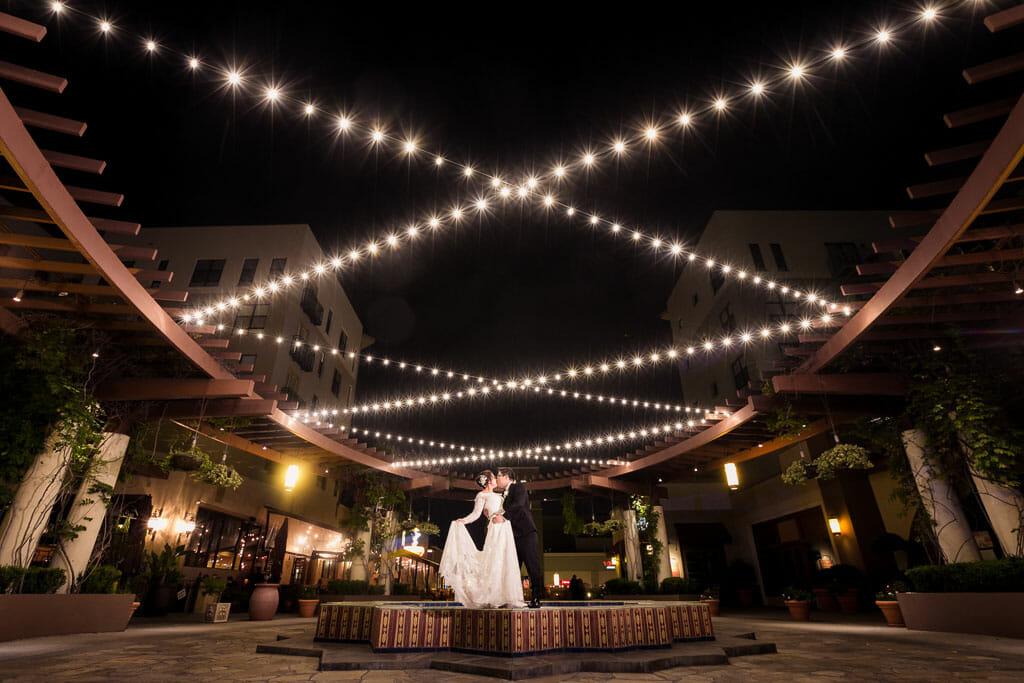 romantic bride and groom portrait on the NOOR terrace at night with string lighting