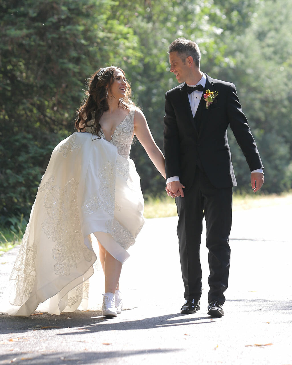 bride in converse shoes walking with groom in los angeles arboretum