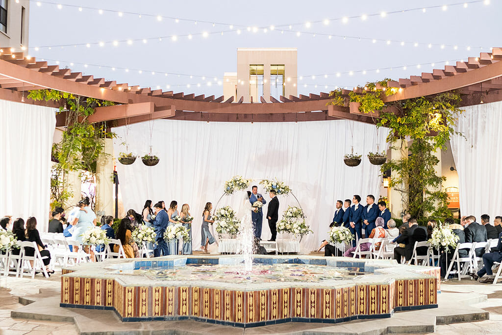 outdoor wedding ceremony on the NOOR terrace in pasadena with fountain and string lights