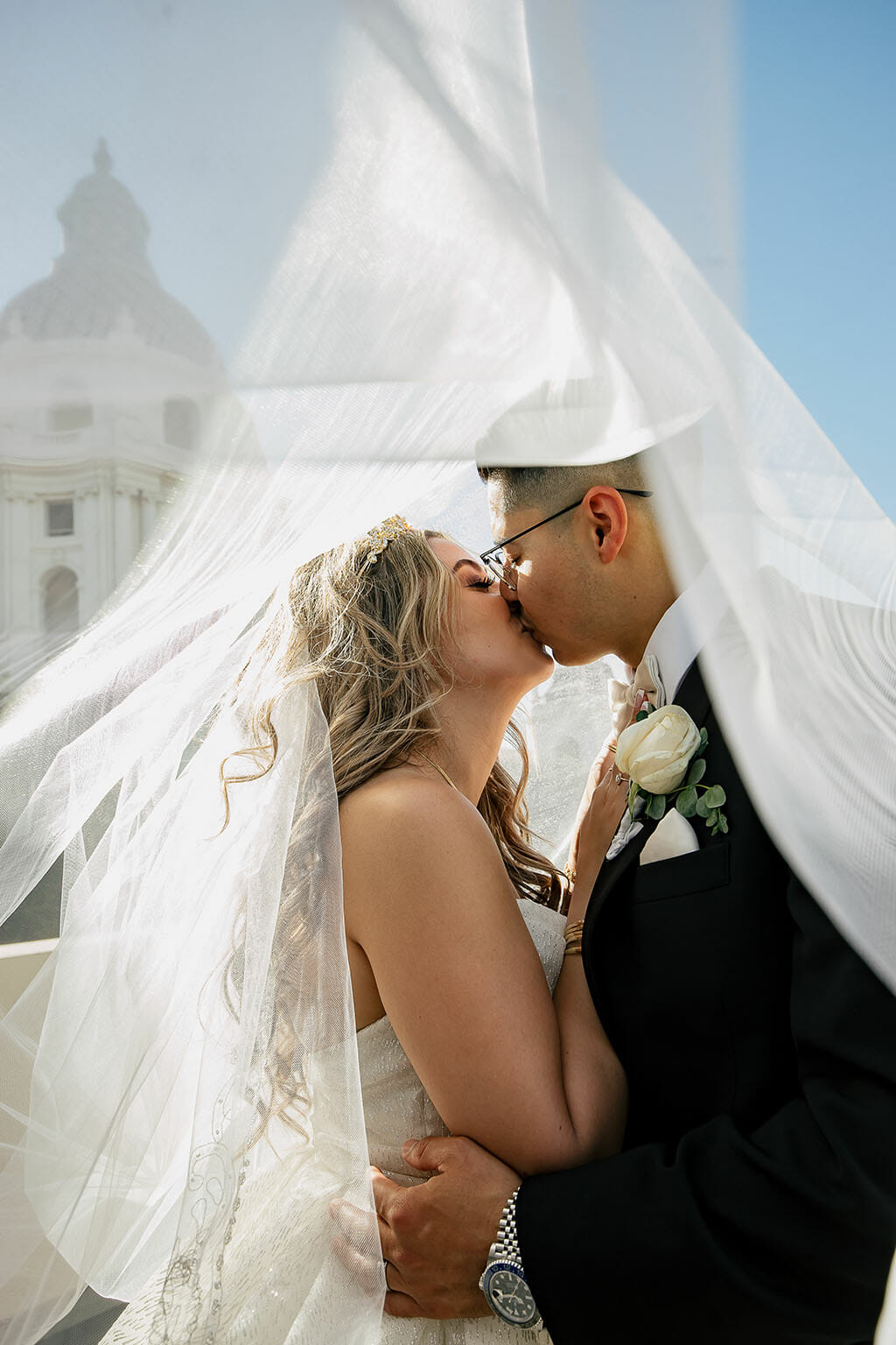 noor los angeles wedding couple kissing under a veil on a sunny day