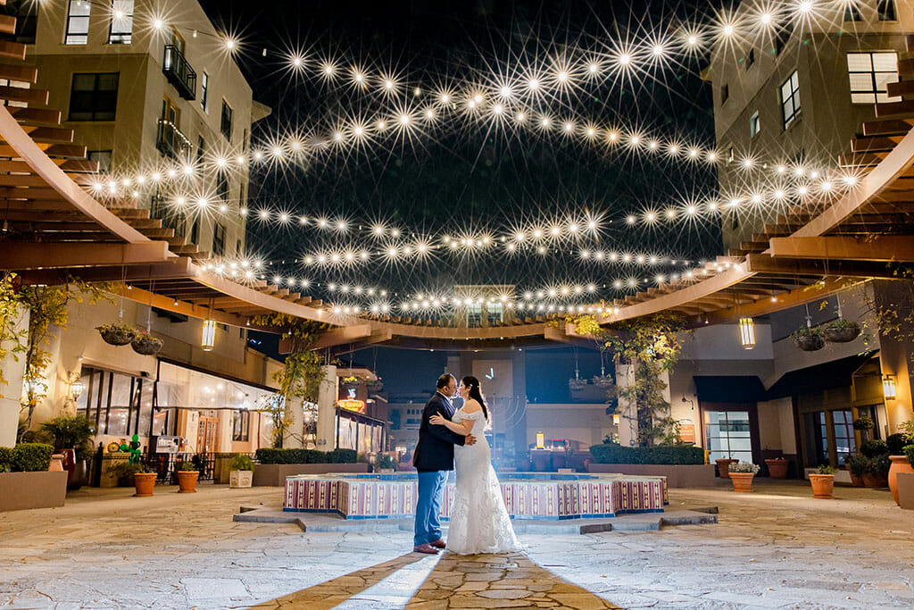 NOOR wedding couple los angeles kissing under string lights on the NOOR terrace wedding event space