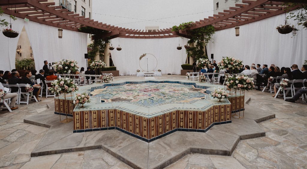wedding ceremony setup on the noor terrace with circular wedding arch and blush floral decor