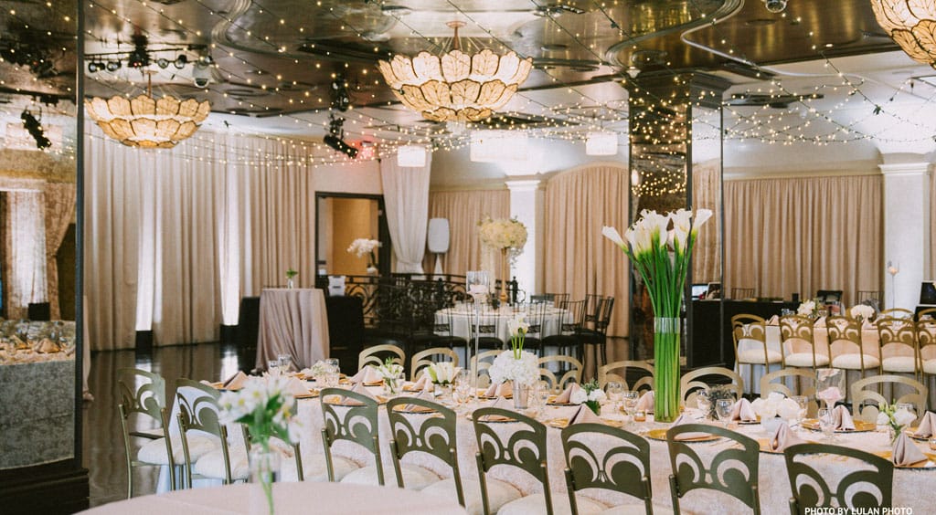 corporate event venue space in pasadena setup for dinner reception with tables, chairs, floral centerpieces and string lights