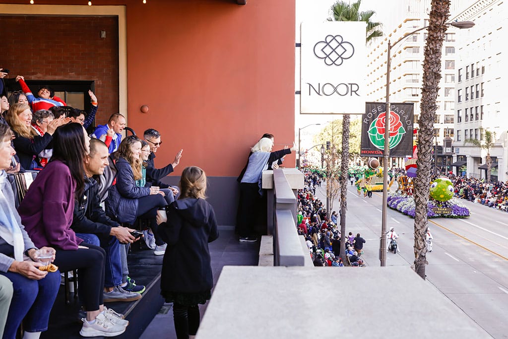 rose parade champagne brunch VIP guests at NOOR enjoying the rose parade from the sofia balcony