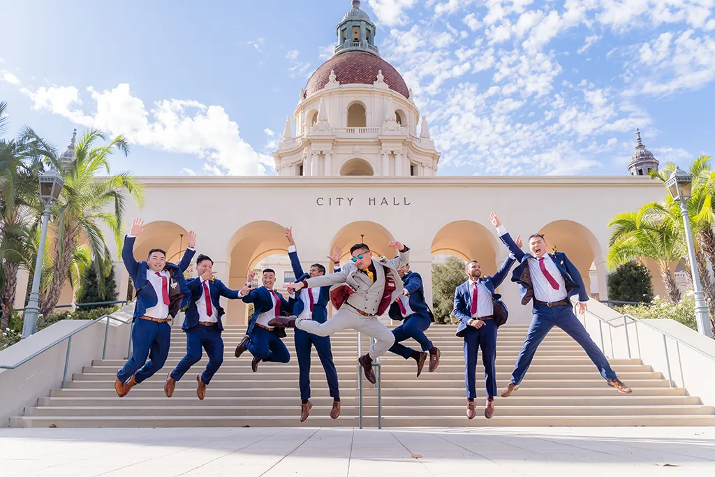 groom and groomsmen jumping for joy outside pasadena city hall